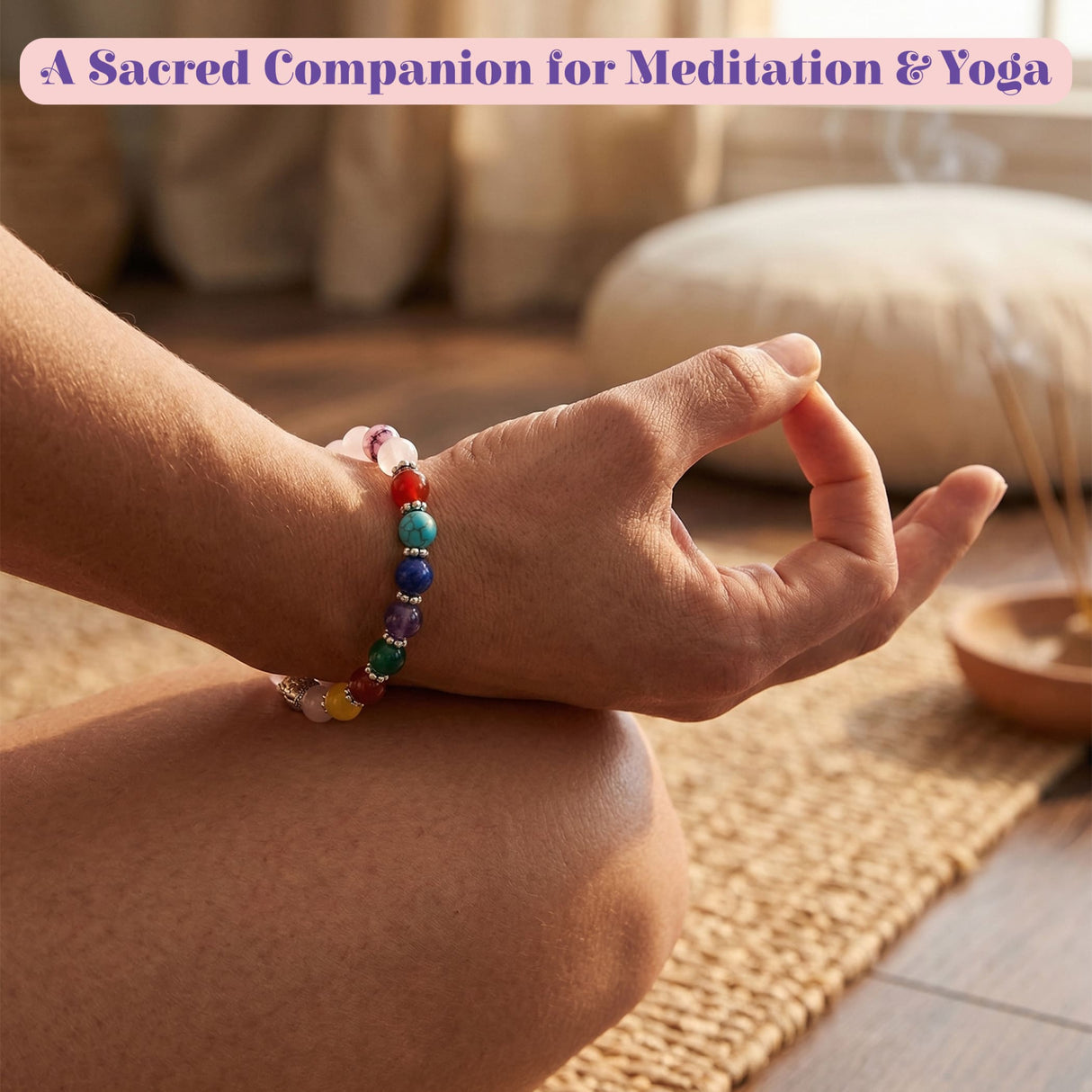 A colorful LOVENSPIRE 7 chakra rose quartz crystal beaded bracelet with Buddha head worn on a wrist for meditation
