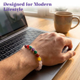 A colorful lovenspire 7 chakra rose quartz crystal beaded bracelet with rainbow gemstones worn on a wrist