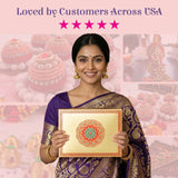 Gold-framed rectangular sweet box with vibrant red and green mandala design on cream surface for Indian sweets packaging