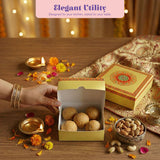 Gold-colored empty mithai box with decorative red and green mandala lid containing light brown sweets for gifting