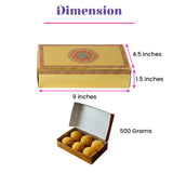 Golden rectangular sweet box with red and green floral mandala design lid containing six round yellow sweets for gifting
