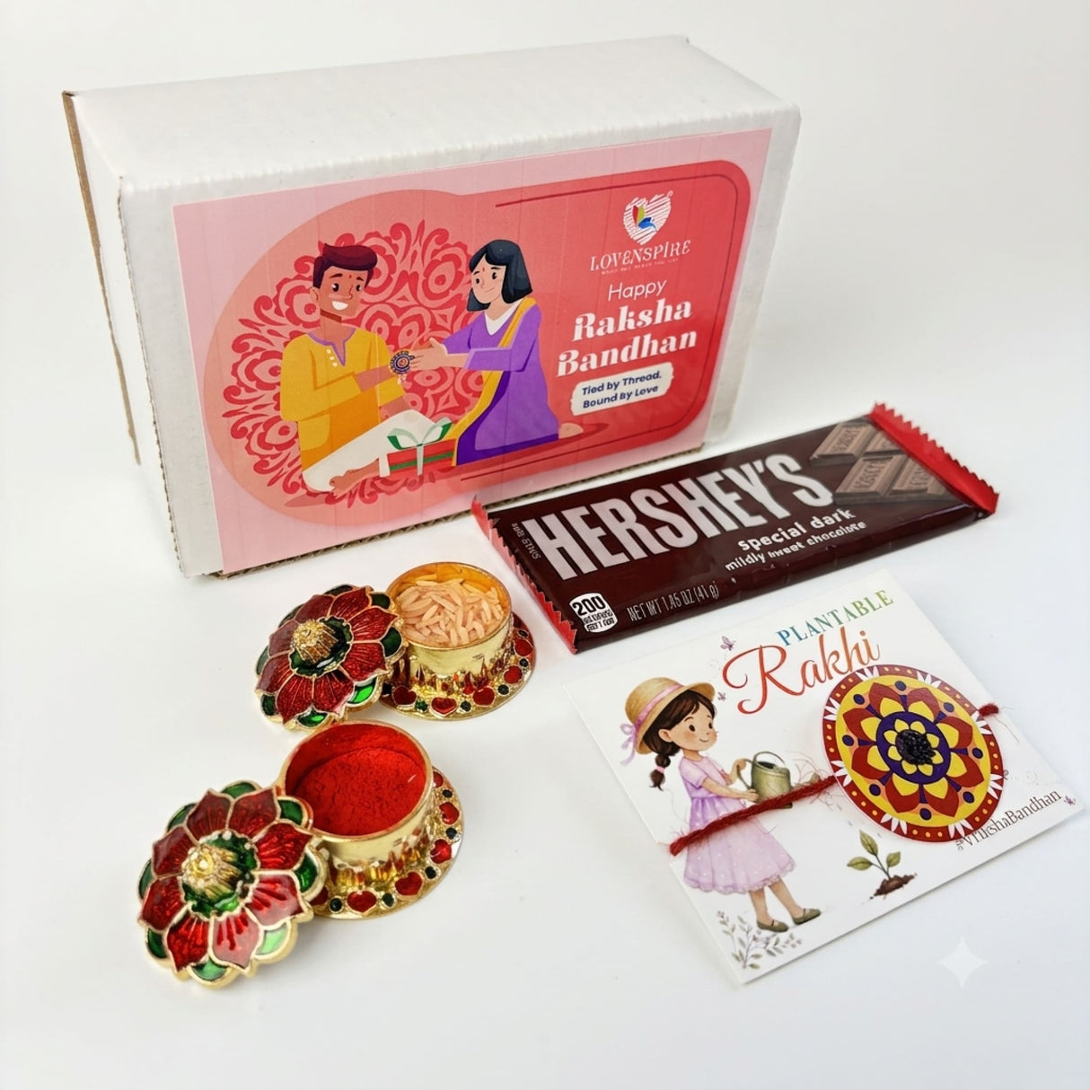 Decorative gold-toned metal gift box with red and green enamel flower designs for designer mandala seed rakhi hamper