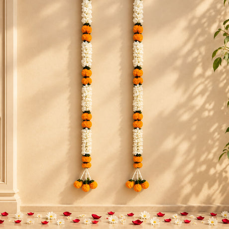 Two vertical artificial jasmine and marigold flower garlands with white and orange marigold blooms for wedding decor