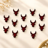 Dark red glossy resin bull head clips arranged in a pattern from indian marathi bindi booklets collection for traditional use