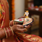 White and gold swan-shaped diya with red accents, ceramic marble Chopra for Pooja and Diwali
