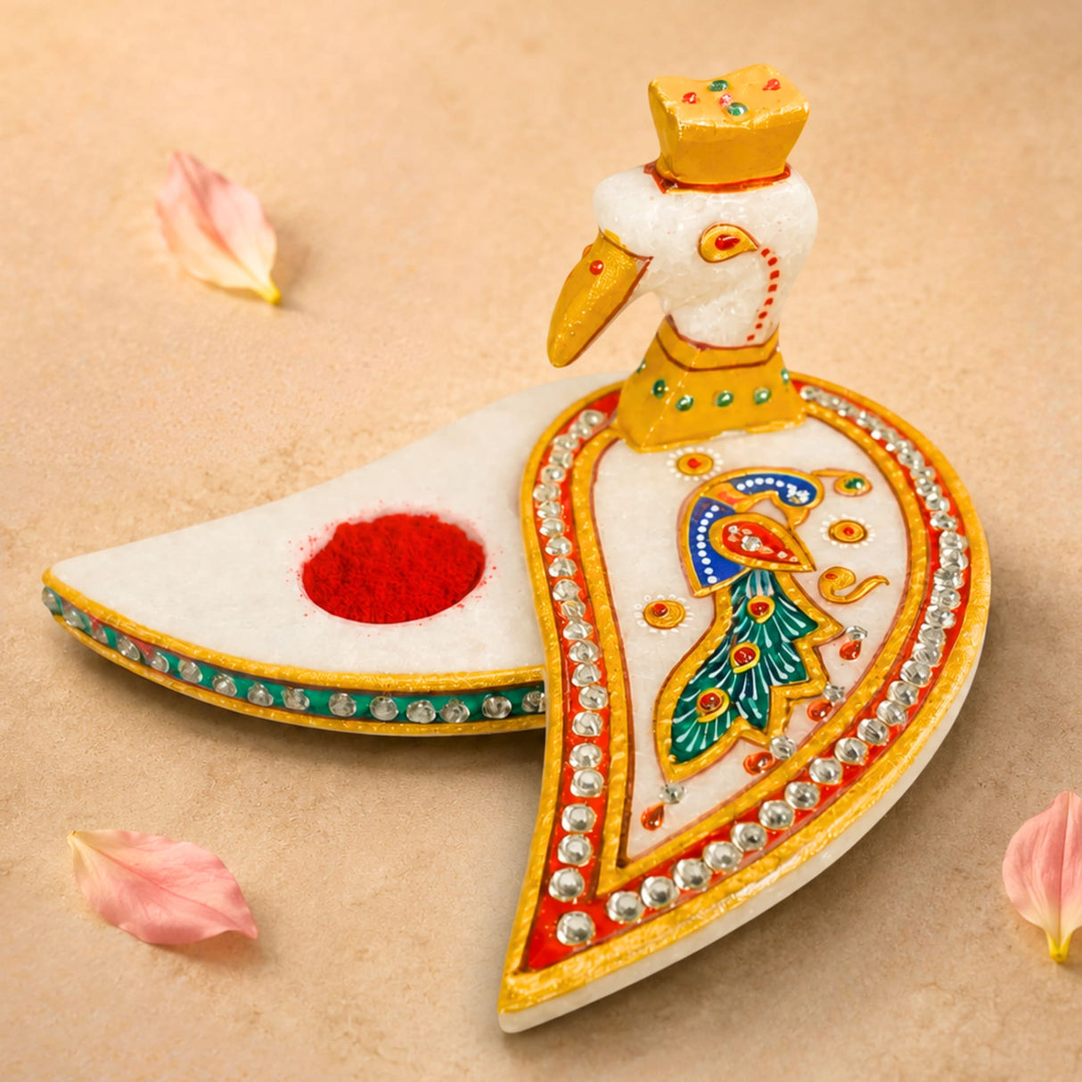 Marble chopra peacock haldi kumkum holder is a white marble incense burner with gold paint and rhinestone details for pooja