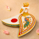 Marble chopra peacock haldi kumkum holder is a white marble incense burner with gold paint and rhinestone details for pooja