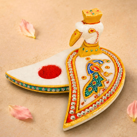 Marble chopra peacock haldi kumkum holder is a white marble incense burner with gold paint and rhinestone details for pooja
