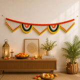 A vibrant orange white green and yellow jumbo marigold jasmine pom-pom garland hanging for festival decoration