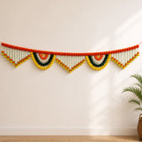 A 9.6 feet jumbo marigold jasmine door toran hanging valance with vibrant orange yellow green pom-poms and white beads