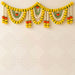 A vibrant yellow white and green artificial marigold jasmine garland with decorative pom-poms for festival pooja decor