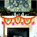 A vibrant orange white and pink artificial marigold jasmine garland with green accents hanging on a fireplace mantel
