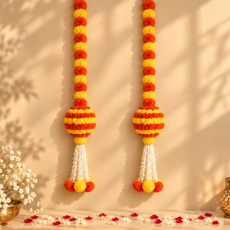 Artificial marigold and jasmine hanging jhoomer garland with vibrant orange yellow pom-poms and white tassels for festive decor