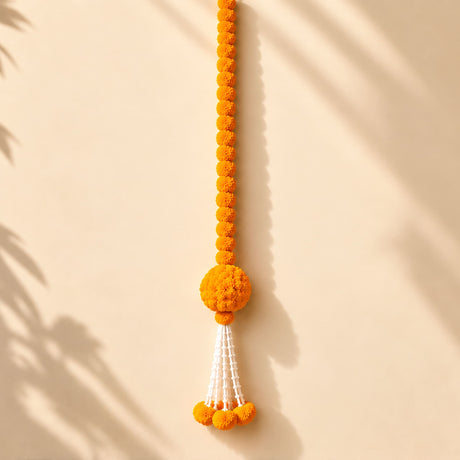 Artificial marigold and jasmine hanging jhoomer garland with vibrant orange pom-pom and white tassels for indian decor