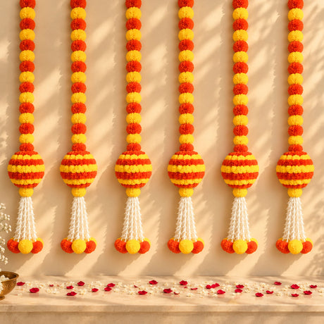Artificial marigold and jasmine hanging jhoomer garland with vibrant orange yellow pom-poms and white tassels for decor