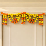 A vibrant orange and yellow artificial marigold mango leaf door toran garland for puja diwali and festive decor