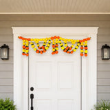 Vibrant orange marigold mango leaf door toran garland above white door