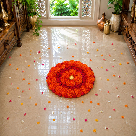 Vibrant orange and red artificial marigold rangoli mat with round tealight holder arranged in concentric circles for diwali decor