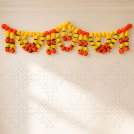 A vibrant yellow and orange artificial marigold garland with green stems for Indian wedding and festival decor