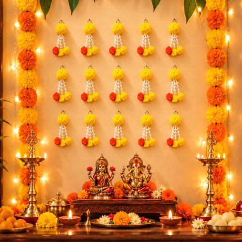 Golden brass statues of goddess lakshmi and lord ganesha on wooden altar with bulk orange and yellow marigold tuberose tassels for diwali decoration