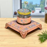 Copper-colored decorative jar stand with floral patterns and ornate legs for Dry Fruits Storage