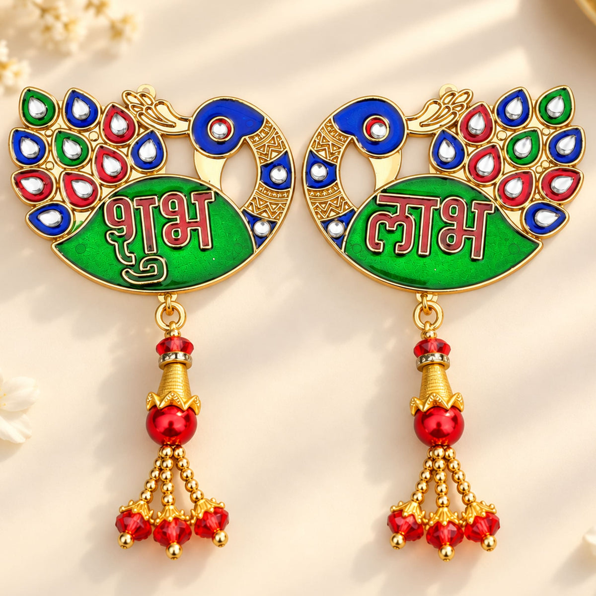 Golden meenakari peacock-shaped door decoration with green enamel body, red blue gemstone eyes, and red bead tassels for diwali gift
