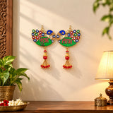 Two ornate meenakari peacock wall hangings in gold with green bodies and colorful feather details for diwali decor