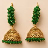 Elegant gold tone indian bali hoop and bead jhumka earrings with green filigree beads for diwali and wedding wear