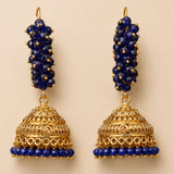 Elegant gold tone Indian Bali jhumka earrings with deep blue faceted beads and intricate filigree for ethnic wear