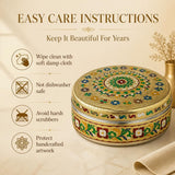 Stainless steel tortilla warmer with lid featuring ornate gold, green, blue, red, and white meenakari enamel design