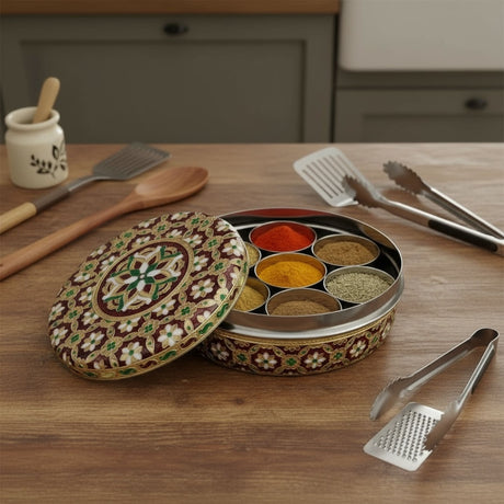 Ornate round steel spice box with seven colorful spice compartments for kitchen decor