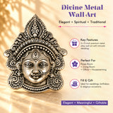 Silver-toned metal durga face wall hanging with intricate filigree and traditional adornments for home decor and puja