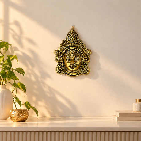 Golden brass metal durga face wall hanging with ornate patterns for home decor puja temple and diwali gifts
