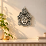 Silver-toned metal durga face wall hanging with intricate headpiece and jewelry for home decor and puja use