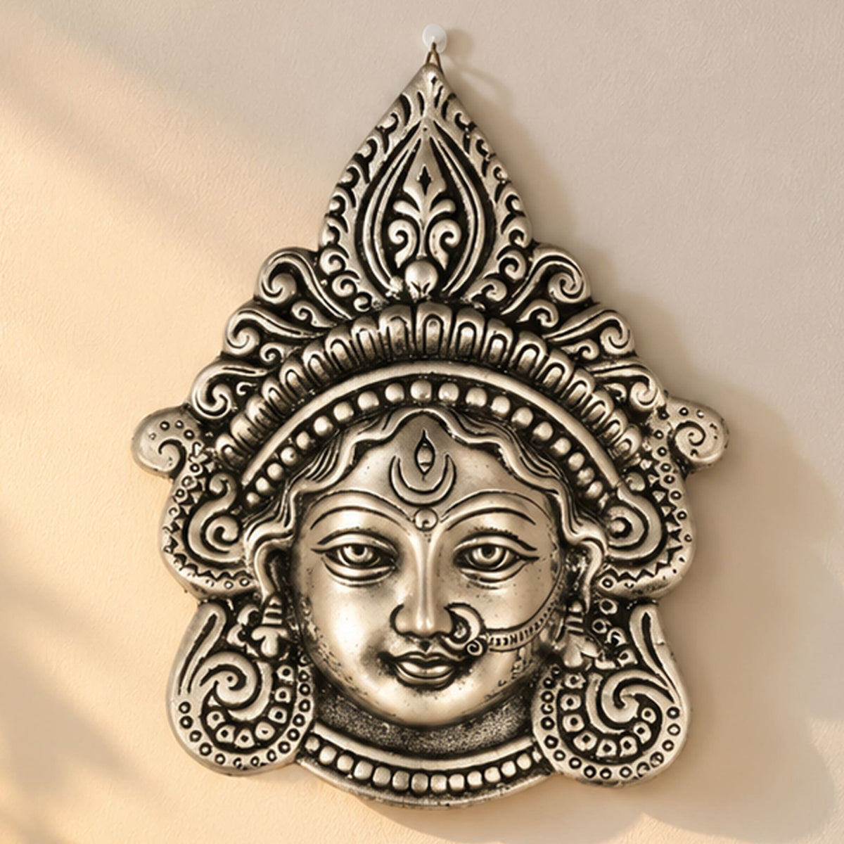 Silver-toned metal durga face wall hanging with intricate patterns for home decor puja temple mandir gifts