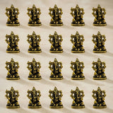 Metal ganesha idol made of golden brass with intricate detailing and polished finish for home temple and decor