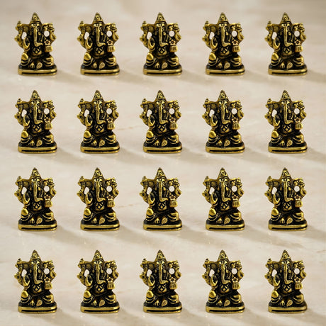 Metal ganesha idol made of golden brass with intricate detailing and polished finish for home temple and decor