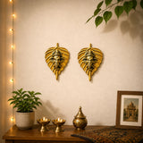 Golden metal leaf ganesha wall hanging decor with intricate ganesha head carvings for home and office interior decoration
