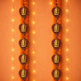 2 pcs metal leaf ganesha wall hanging with golden ganesha ornaments and maroon bases on orange marigold garlands for decor