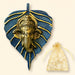 Golden metal leaf ganesha wall hanging decor with intricate detailing on textured blue leaf background for home and office