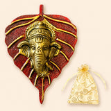 Golden ganesha head mounted on a textured red metal leaf plaque decorative indian art wall hanging for home and office decor
