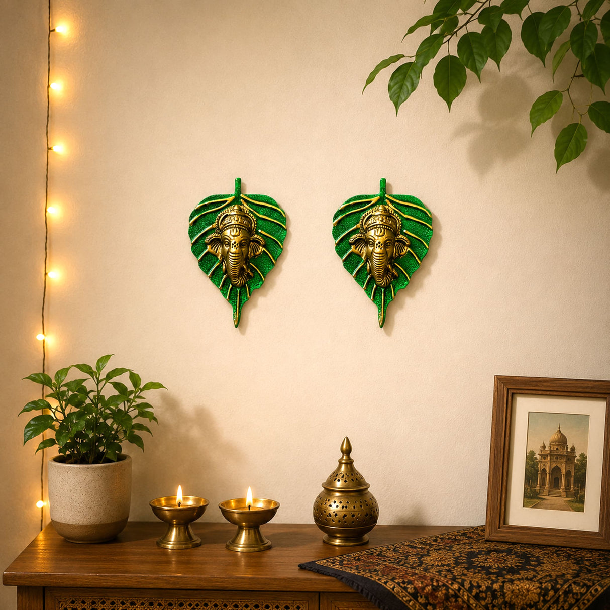 Metal leaf ganesha wall hanging decor featuring green leaf shape with golden ganesha figures for home and office use