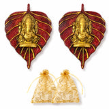 Red and gold metal leaf-shaped wall hanging featuring a central golden Ganesha for Diwali decor and pooja use