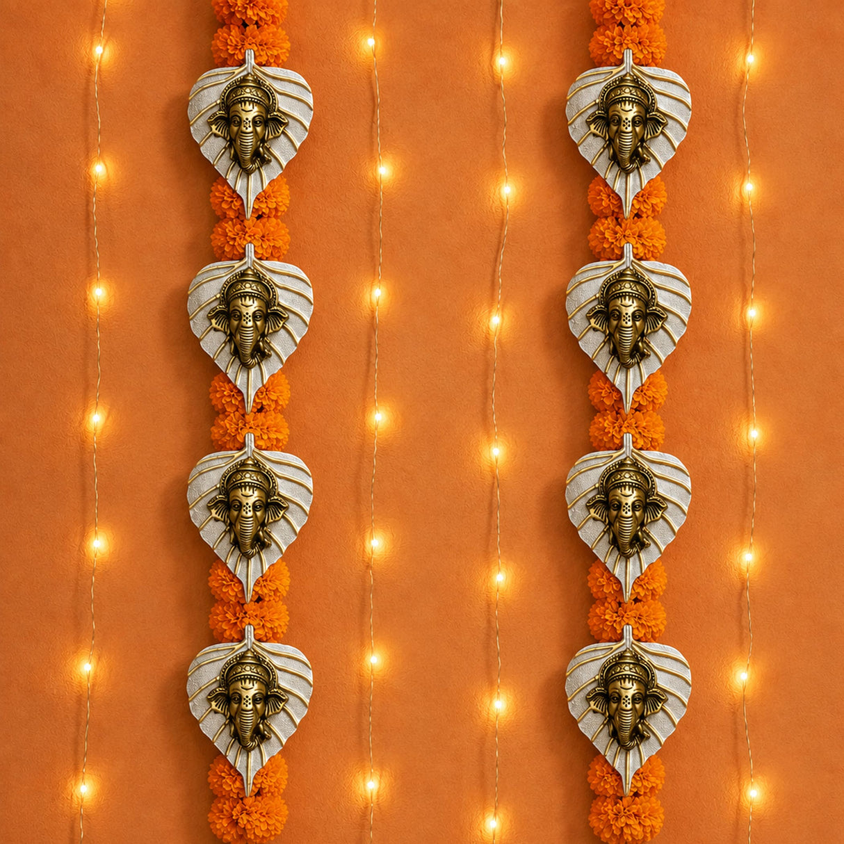 Heart-shaped metal leaf ganesha wall hanging decor with bronze deity figures and orange marigold garlands for diwali and home use