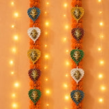 Metal leaf Ganesha wall hanging decor featuring metallic finish head ornaments in leaf-shaped frames with orange marigold garlands