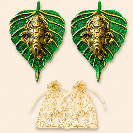 Metal leaf ganesha wall hanging decor in green with golden ganesha faces featuring intricate detailing for home use