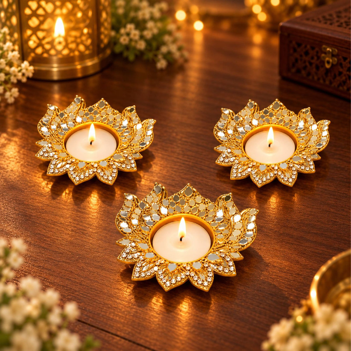 Gold-plated lotus-shaped metal tea light candle holders with mirrored crystal accents for diwali pooja and home decor
