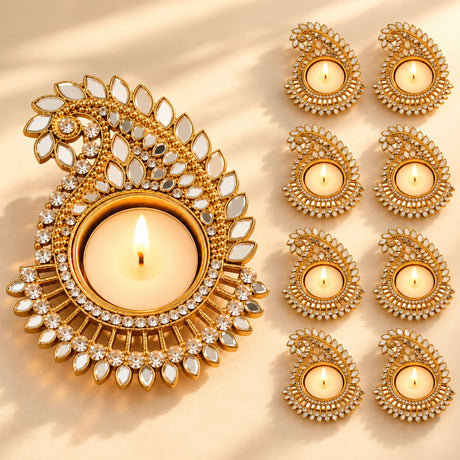Metal paisley design mirror work gold-colored ornate diya with crystal embellishments for festive home décor and pooja