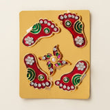 Metallic lakshmi charan paduka decorative red and green foot-shaped stickers with silver rhinestones on gold backing plate
