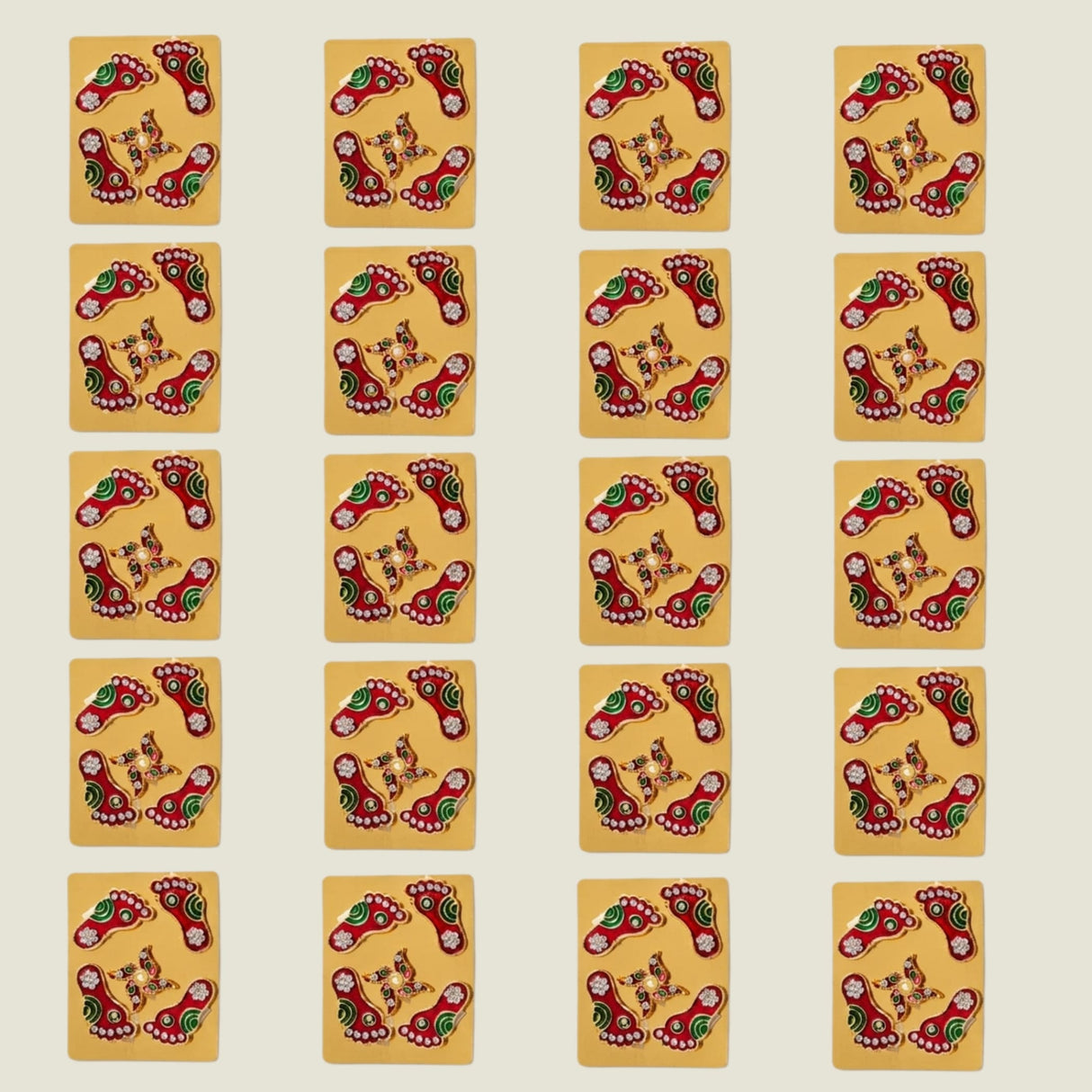 Metallic lakshmi charan paduka red and green enamel pins with gold accents on yellow cards for diwali decoration
